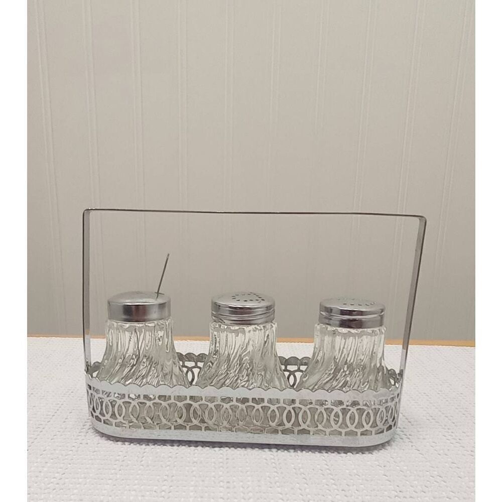 Vintage Crystal like l salt and pepper in silver plated caddy